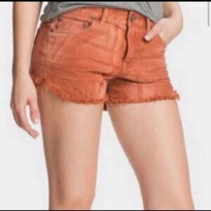 Burnt orange tie dye Free People jean shorts size 24.